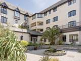 Pendennis Tides' balcony is on the first floor, just to the left of the big palm tree.