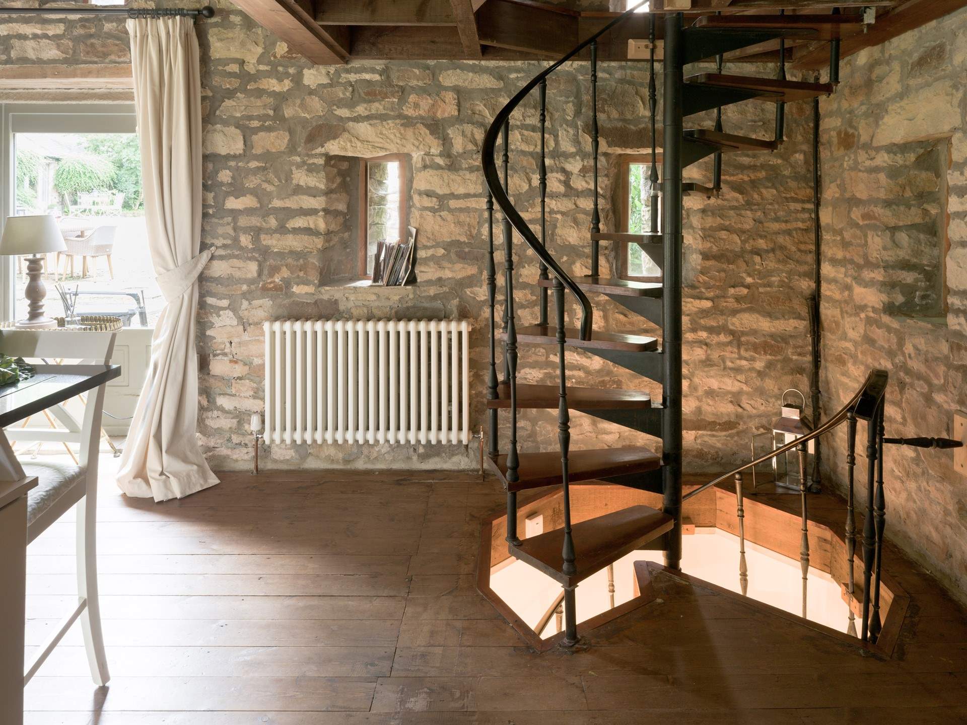 A stylish spiral staircase leads you to the bedrooms downstairs or the mezzanine upstairs. 