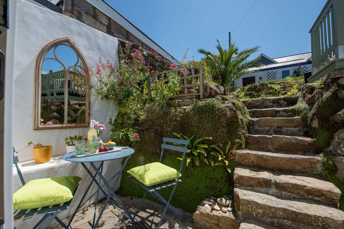 A secluded spot for al fresco dining. Tread carefully on the steps to the upper level of garden.