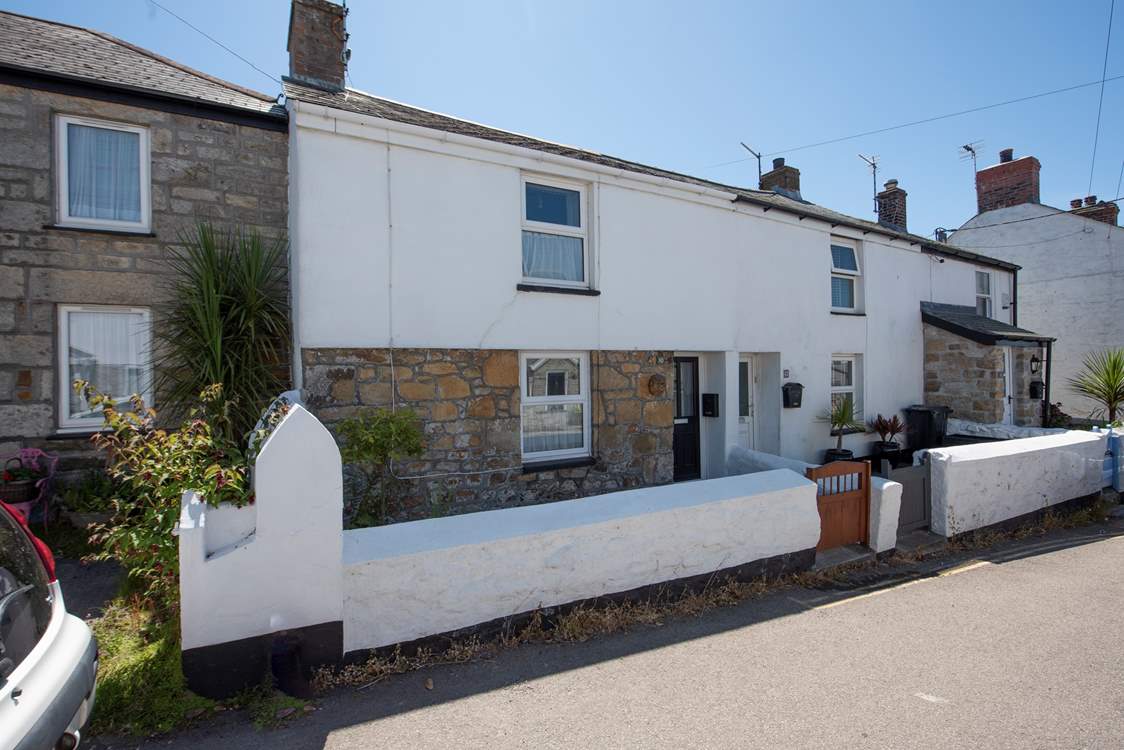 Copper Bal Cottage sits in a row of similar cottages.