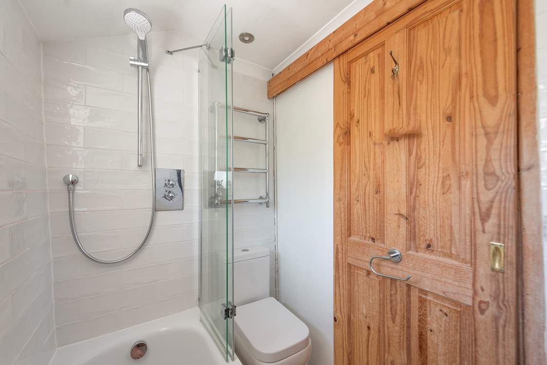 The very modern bathroom with bath and fitted shower.