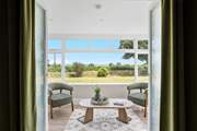 The little sun-room leads off from the sitting-room. From here you can also access the garden.