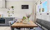 The old garage doors have been cleverly crafted to create a feature in the room. - Thumbnail Image