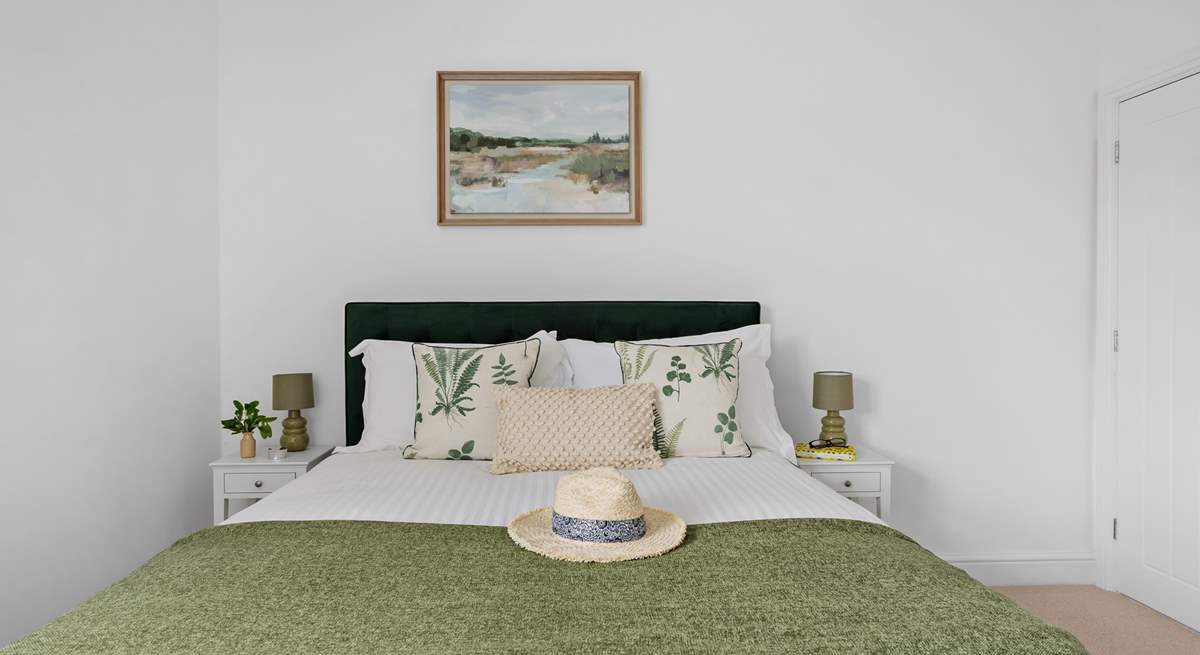 A comfy king-size bed awaits in bedroom 1.