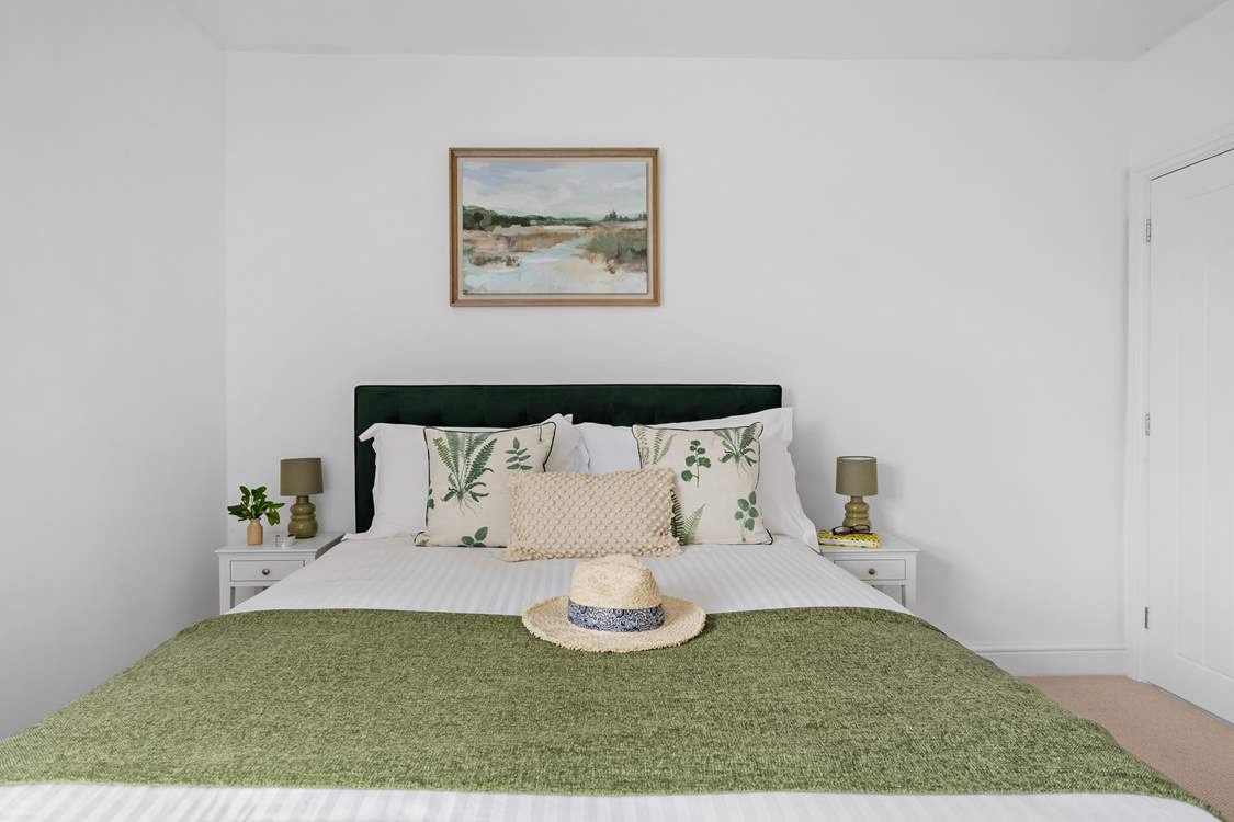 A comfy king-size bed awaits in bedroom 1.
