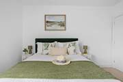 A comfy king-size bed awaits in bedroom 1.