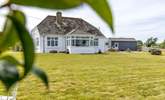The large front garden will delight everyone, the perfect spot for soaking up the sun and  playing garden games. - Thumbnail Image