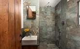 Refresh in the luxe bathroom with a waterfall shower, sink and WC. - Thumbnail Image