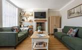 Relax into the comfy sofas and light the wood-burner for a cosy night in. - Thumbnail Image