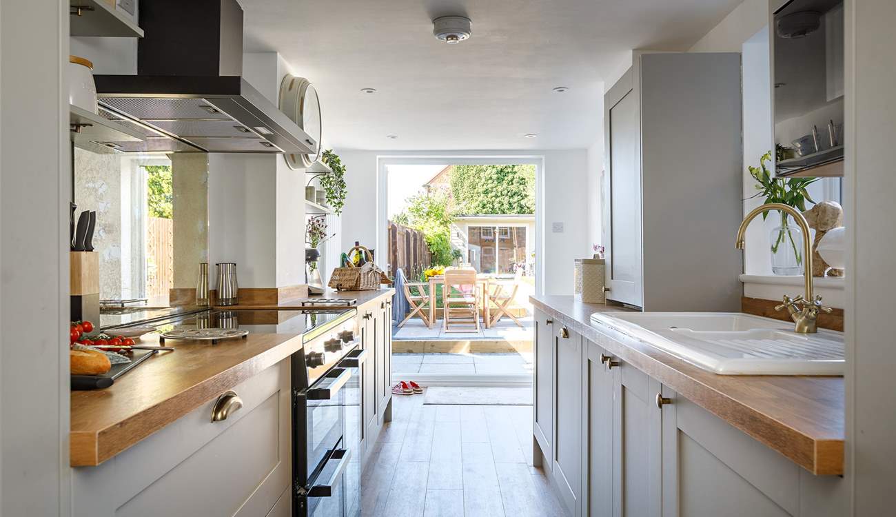 A gorgeous modern kitchen with all 'mod-cons'  leads you to the pretty enclosed garden..