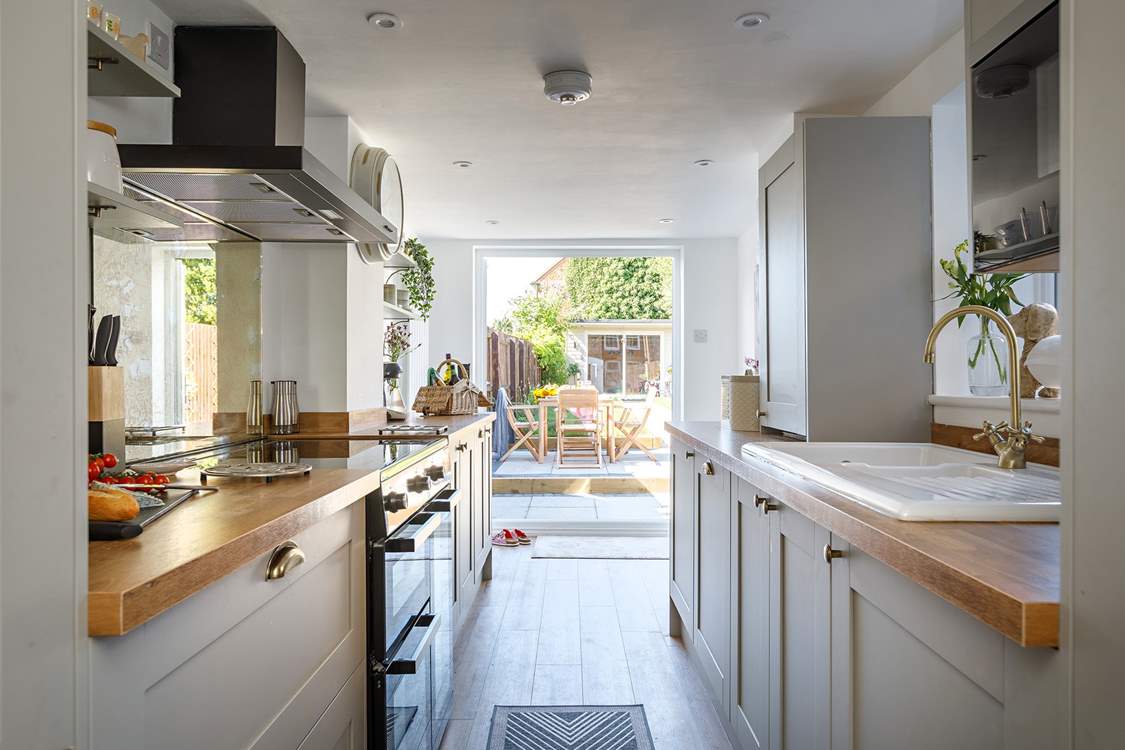 A gorgeous modern kitchen with all 'mod-cons' leads you to the pretty enclosed garden..