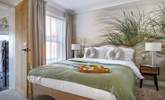 The relaxed principal bedroom with king-size bed and luxurious en suite bathroom. - Thumbnail Image