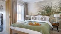 The relaxed principal bedroom with king-size bed and luxurious en suite bathroom.