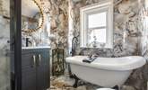Relax in the roll-top tub in the stylish bathroom, there is also a wonderful shower. - Thumbnail Image