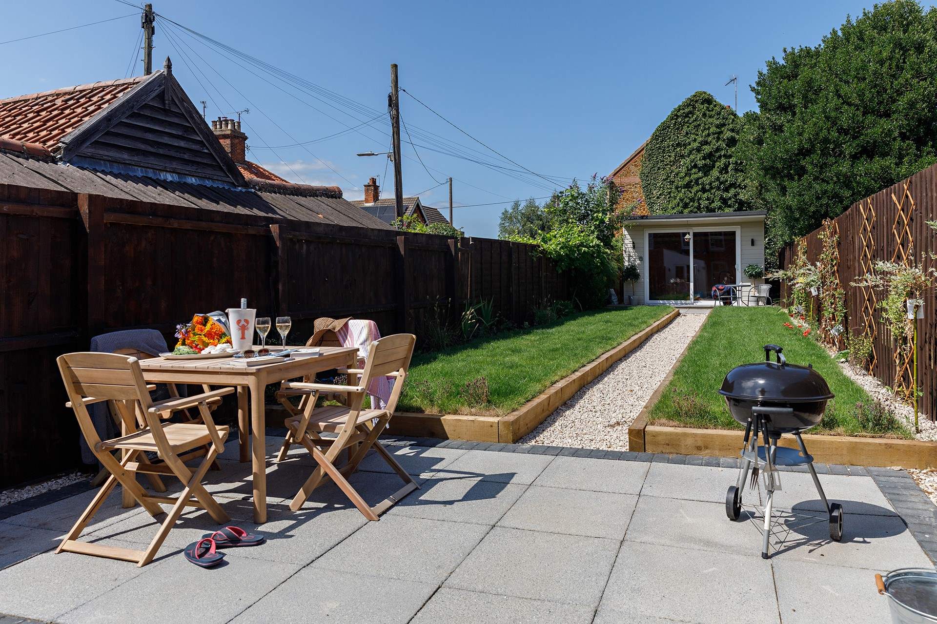 The rear garden complete with grape vine and Summer house/Games room.
