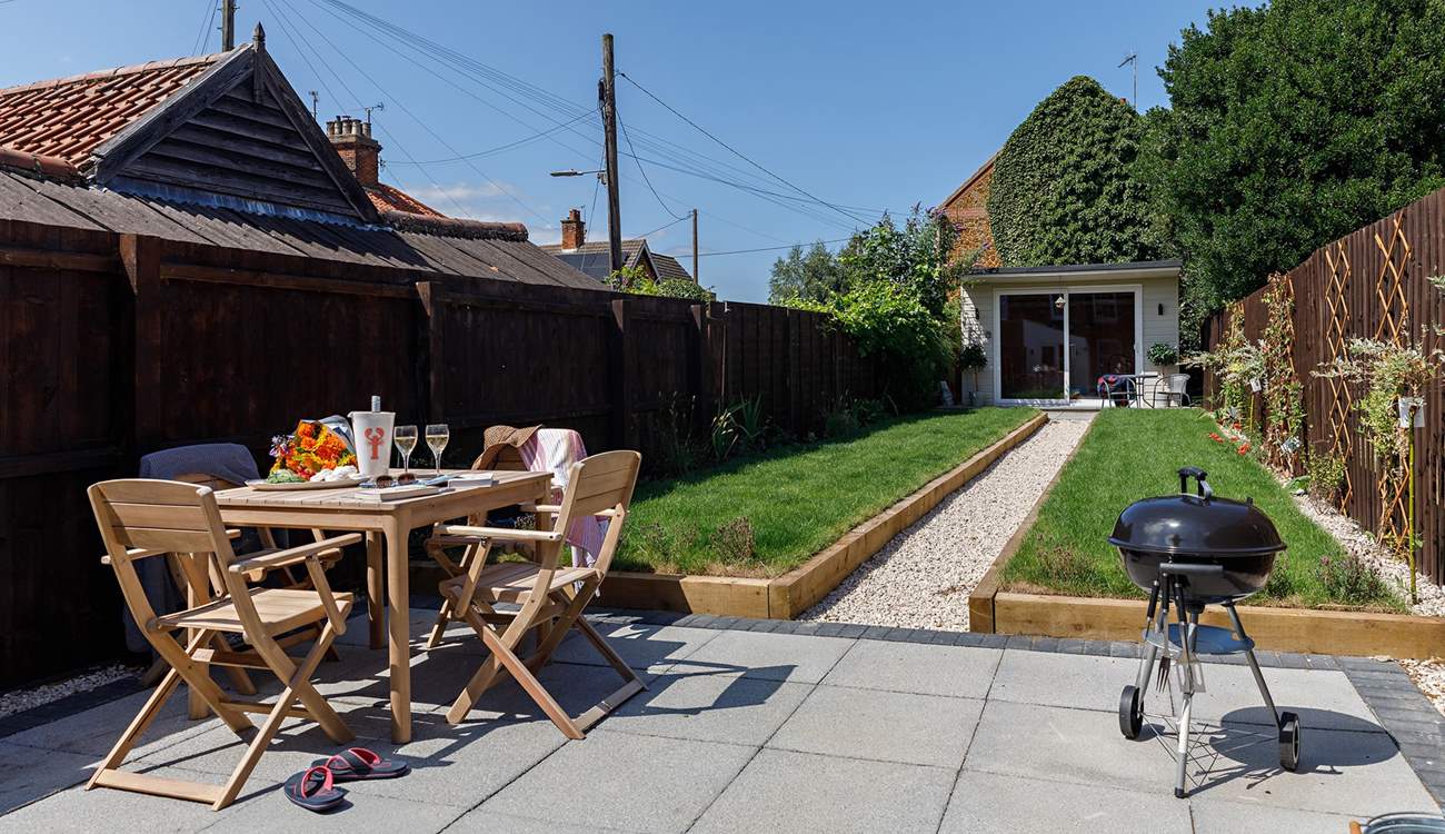 The rear garden complete with grape vine and Summer house/Games room.