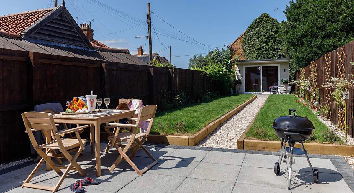 The rear garden complete with grape vine and Summer house/Games room.