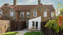 Looking down the garden to the cottage from the games room.