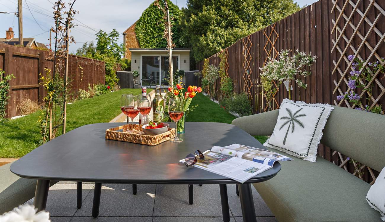 The rear garden complete with grape vine and Summer house/Games room.