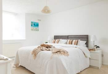 Sink into the huge bed in bedroom 1.