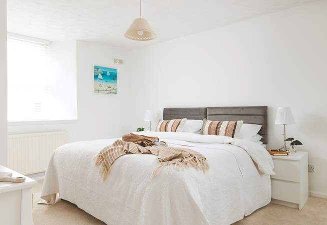 Sink into the huge bed in bedroom 1.