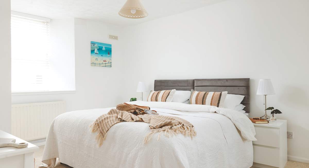 Sink into the huge bed in bedroom 1.