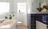 A traditional bathroom with bath and overhead shower. - Thumbnail Image