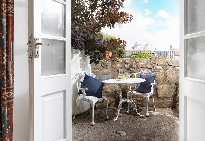The terrace outside of the sitting-room showing the flags on the promenade in the distance.