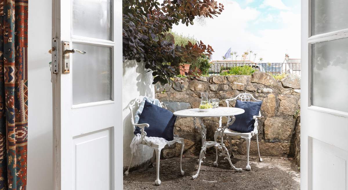 The terrace outside of the sitting-room showing the flags on the promenade in the distance.