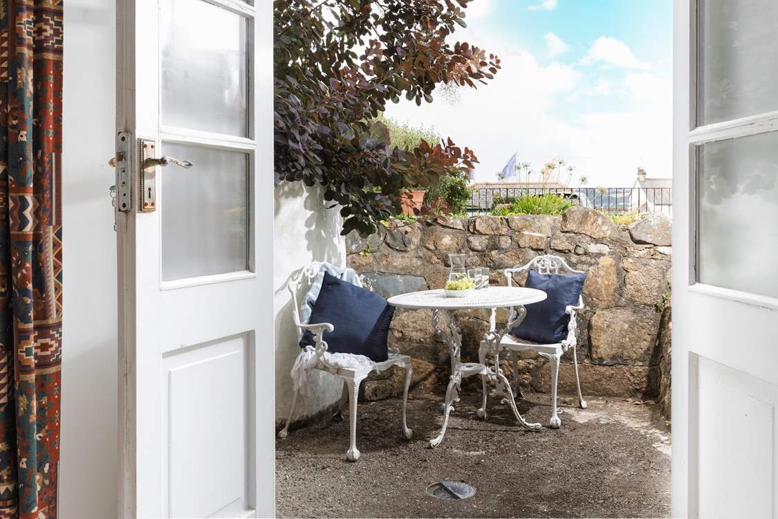 The terrace outside of the sitting-room showing the flags on the promenade in the distance.