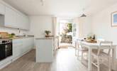 Enter the double doors into a very modern kitchen and dining area. The doors open onto a sweet private courtyard. - Thumbnail Image