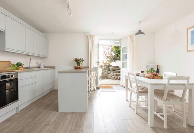 Enter the double doors into a very modern kitchen and dining area. The doors open onto a sweet private courtyard.