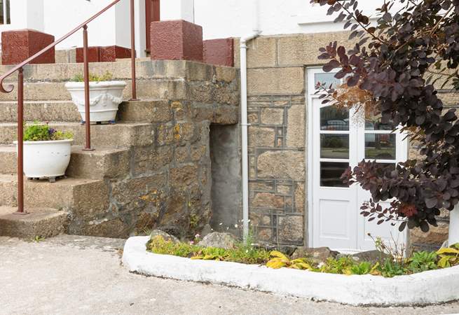 The huge staircase leading up between the two sets of double doors leads to the upstairs apartments.