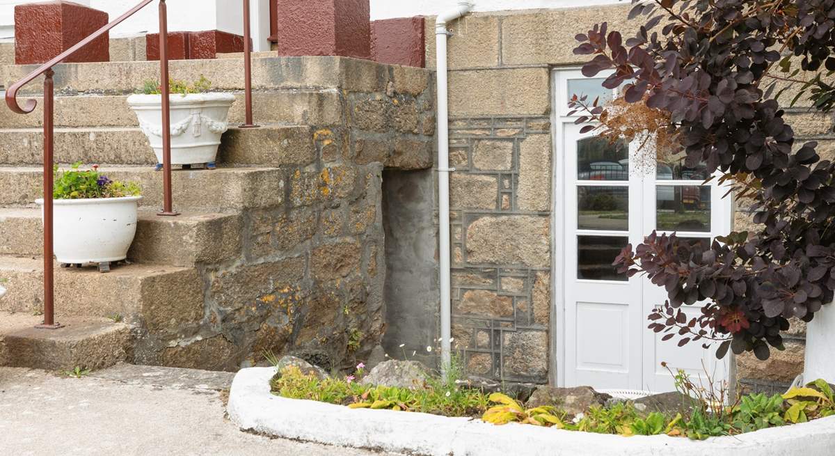 The huge staircase leading up between the two sets of double doors leads to the upstairs apartments.
