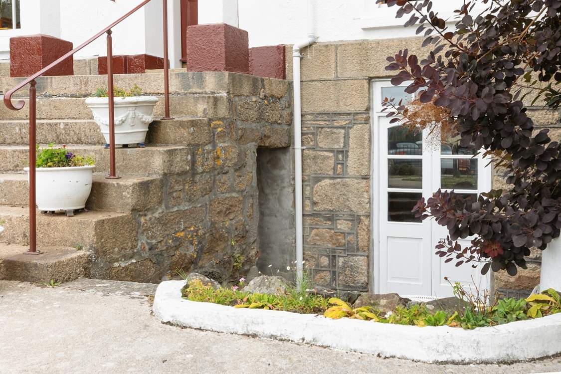 The huge staircase leading up between the two sets of double doors leads to the upstairs apartments.
