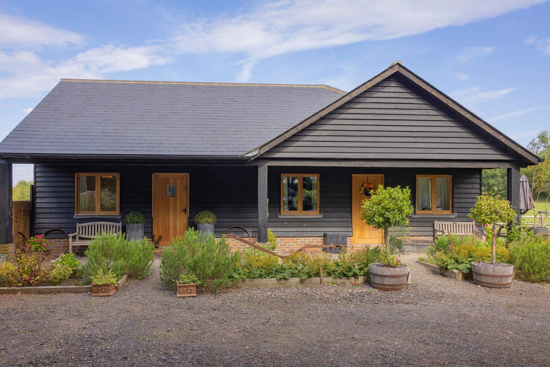 This rustic semi-detached cottage is situated on a working horse farm nestled in the Sussex countryside.