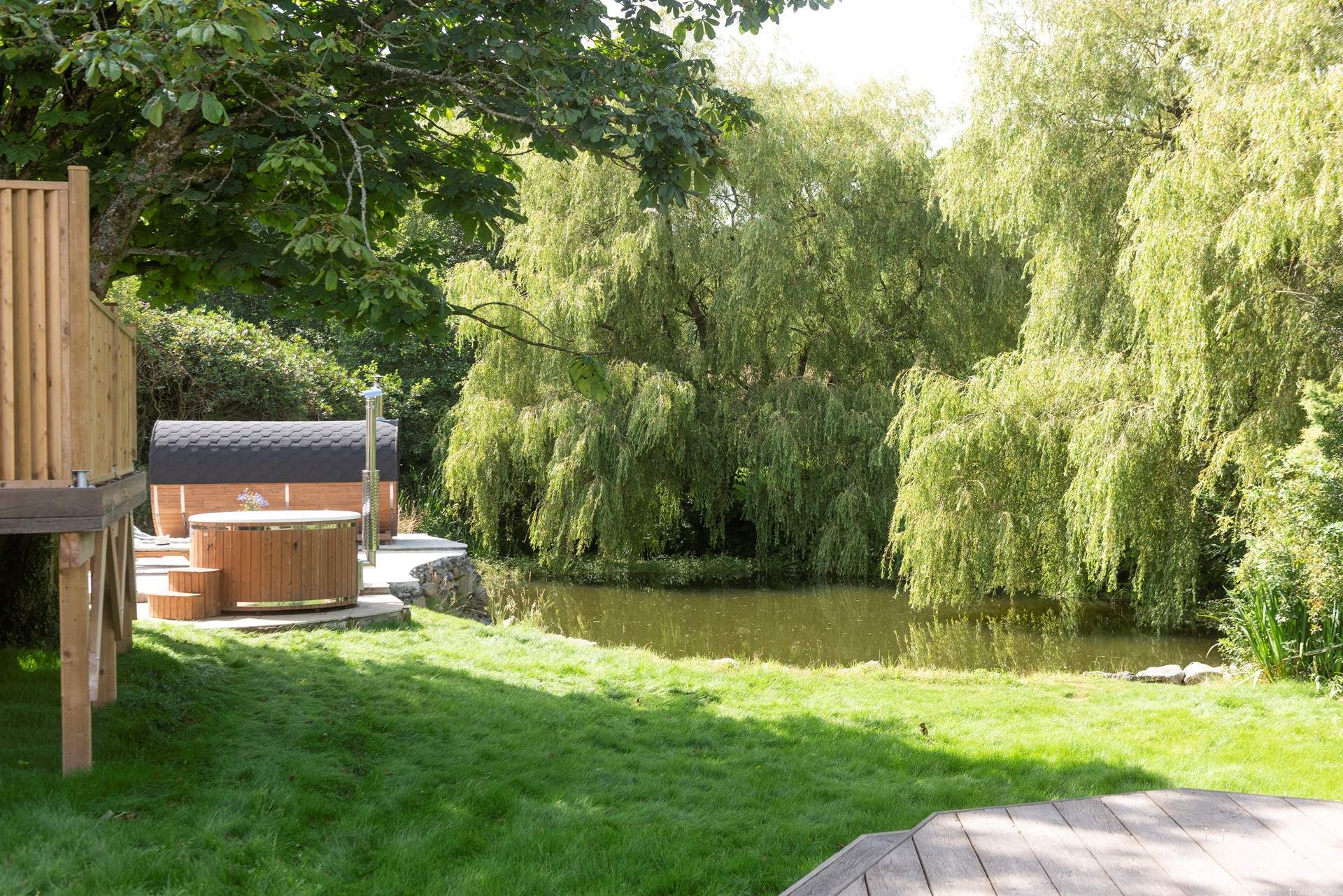 The wild swimming pond and spa area is shared with other guests.