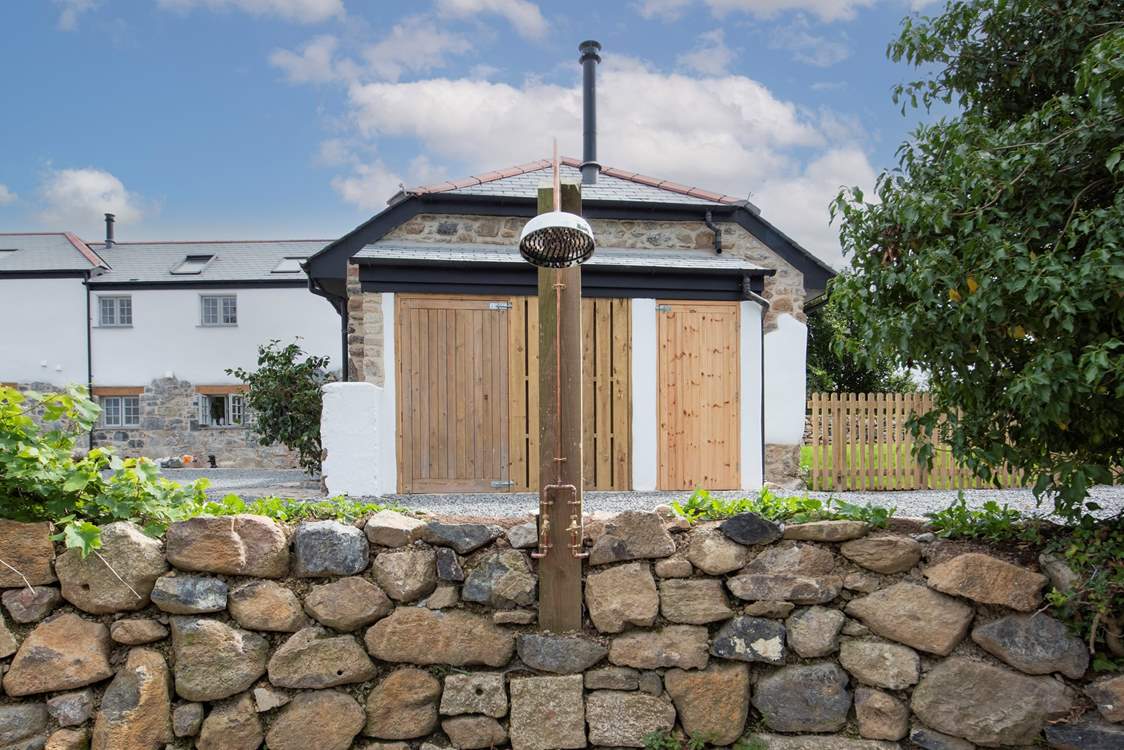 The outdoor shower runs warm water.