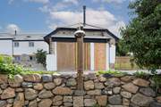 The outdoor shower runs warm water.