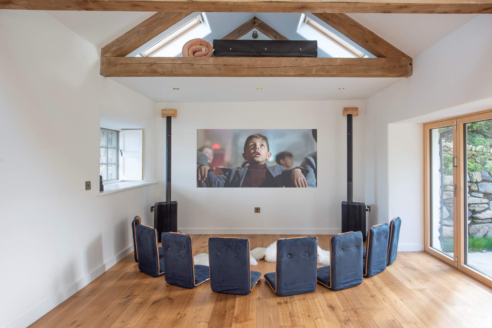 The communal yoga and film space is situated in the courtyard. Private film nights can be reserved in-house and are inclusive.