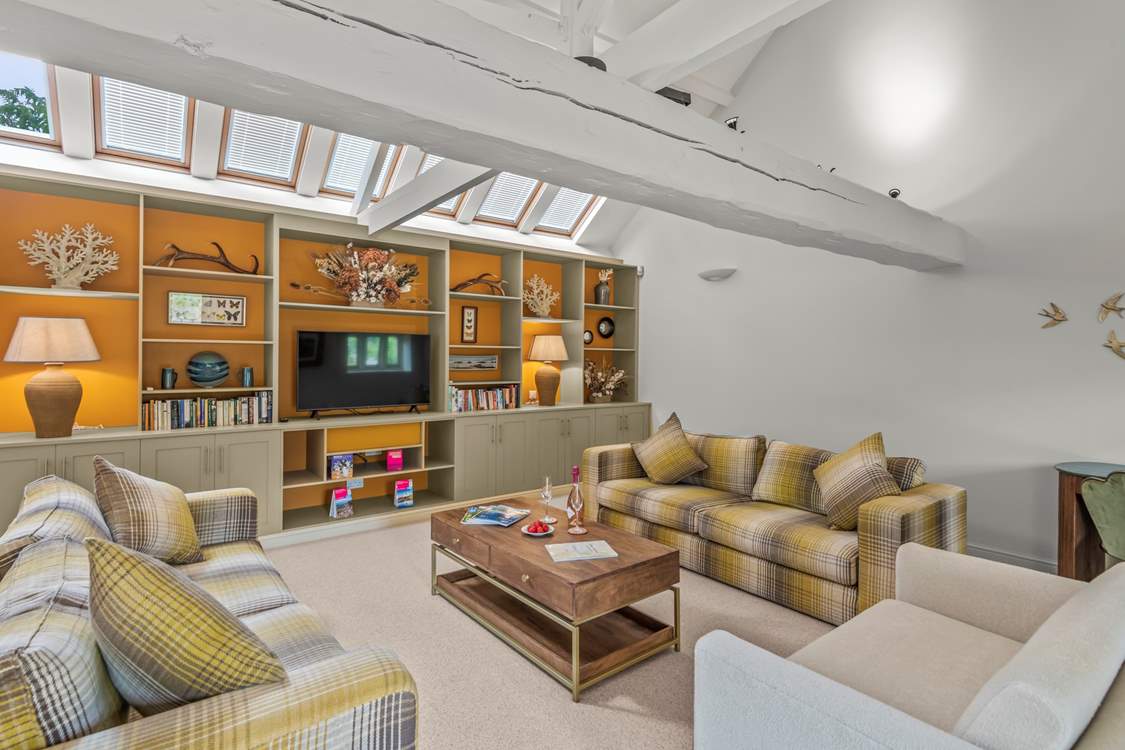 The sitting-room is super spacious offering plentiful comfy seating to truly relax in.