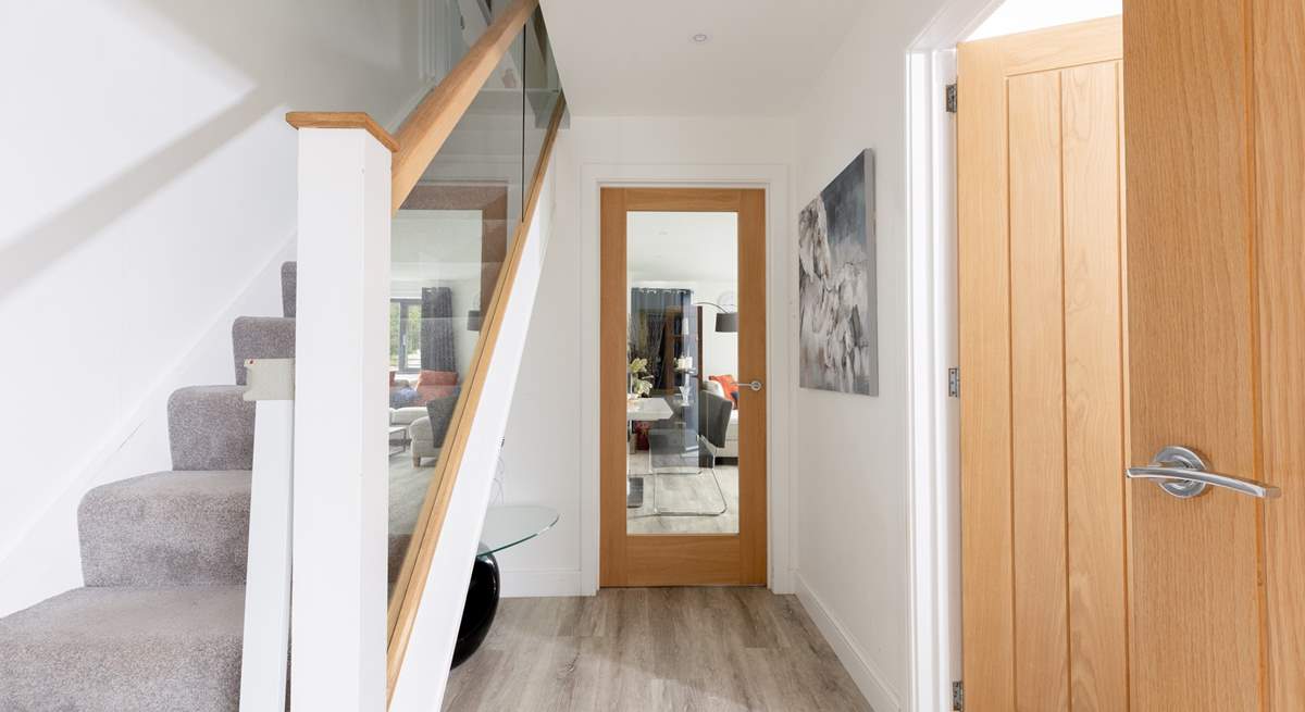 The entrance hall leading into the open plan living space. There is a utility-room on your left and a handy downstairs cloakroom.