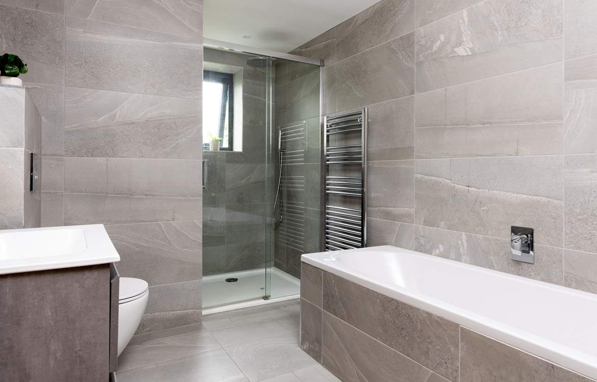 The stylish tiled family bathroom on the first floor with both a bath and separate power shower.