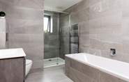 The stylish tiled family bathroom on the first floor with both a bath and separate power shower.