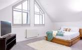 Bedroom 3 is a huge bedroom with a private en suite shower-room, scenic sea views and a Smart TV. - Thumbnail Image