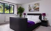 Bedroom 2 has a king-size bed with a Smart TV. - Thumbnail Image