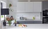 The kitchen is full of modern appliances, including its own wine fridge. - Thumbnail Image