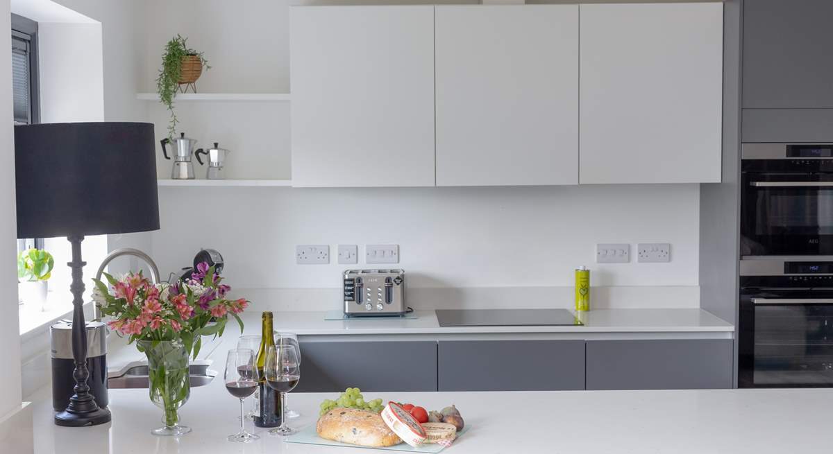 The kitchen is full of modern appliances, including its own wine fridge.