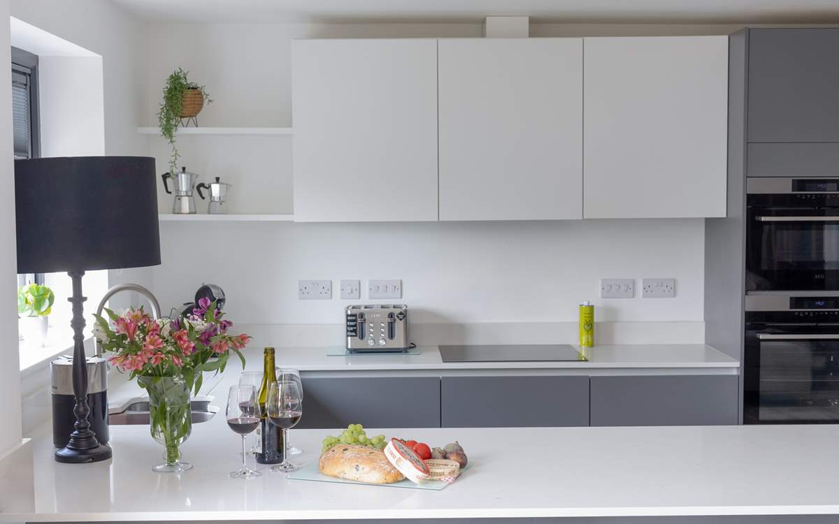 The kitchen is full of modern appliances, including its own wine fridge.