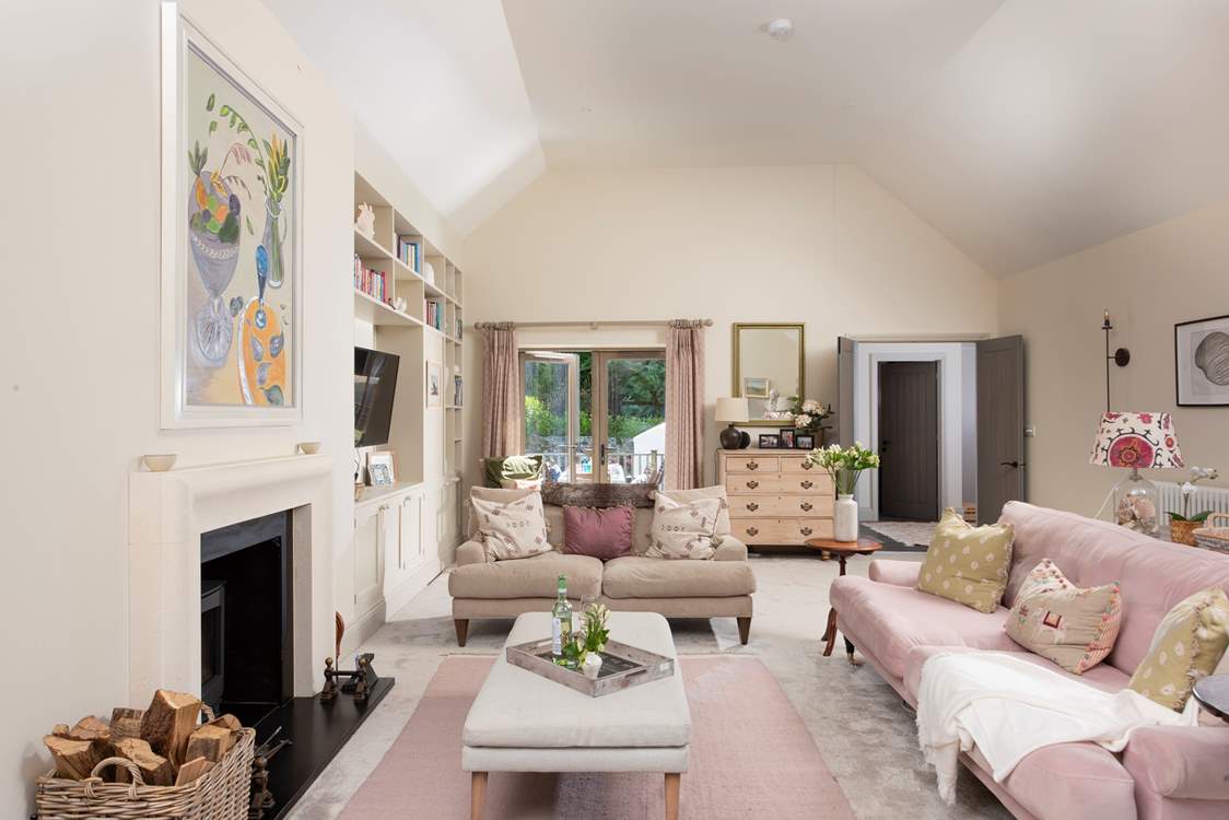 The sitting-room boasts soft elegance and soaring ceilings.